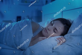 stock-photo-woman-peacefully-sleeping-in-bed-at-night-554478352.jpg