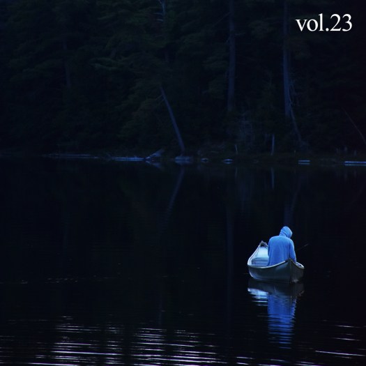 Cover of Cottage Country volume 23 with man on a dark lake in a canoe