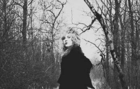 Lady running down the path in the barren woods