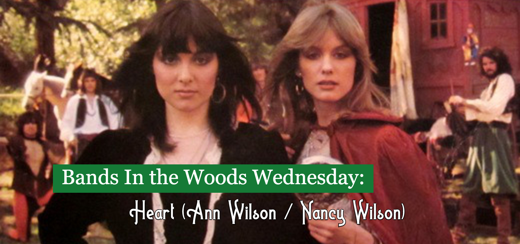 Ann Wilson and Nancy Wilson of Heart stand outdoors in front of a Gypsy caravan
