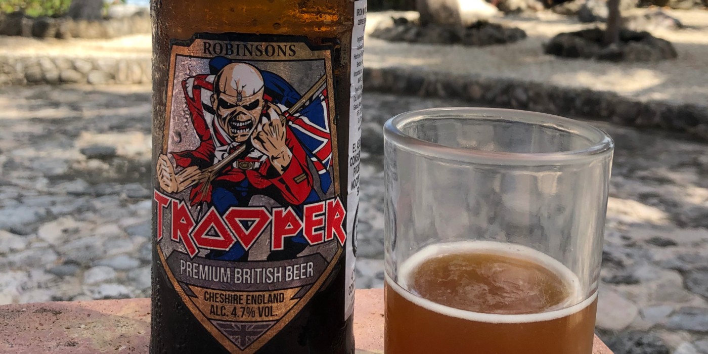Iron Maiden Trooper Beer beside a glass of beer