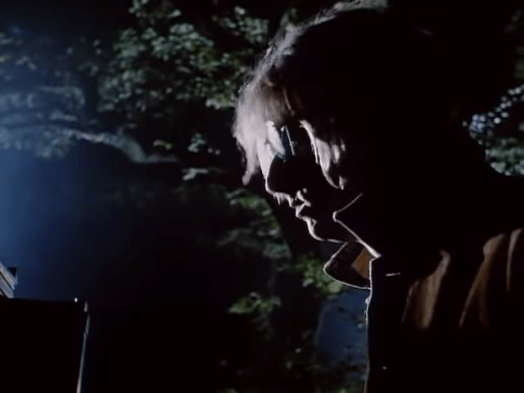 Profile of Mark Hollis in sunglasses in Talk Talk 's "Life's What You Make It" Video in the forest